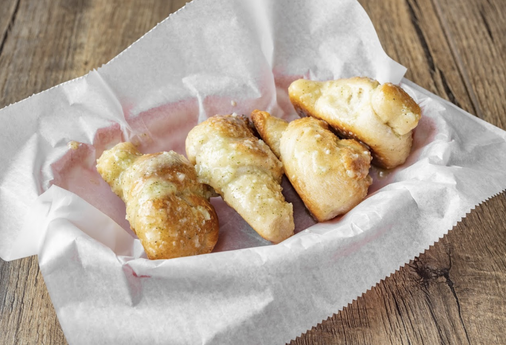 Garlic knots in a paper-lined tray